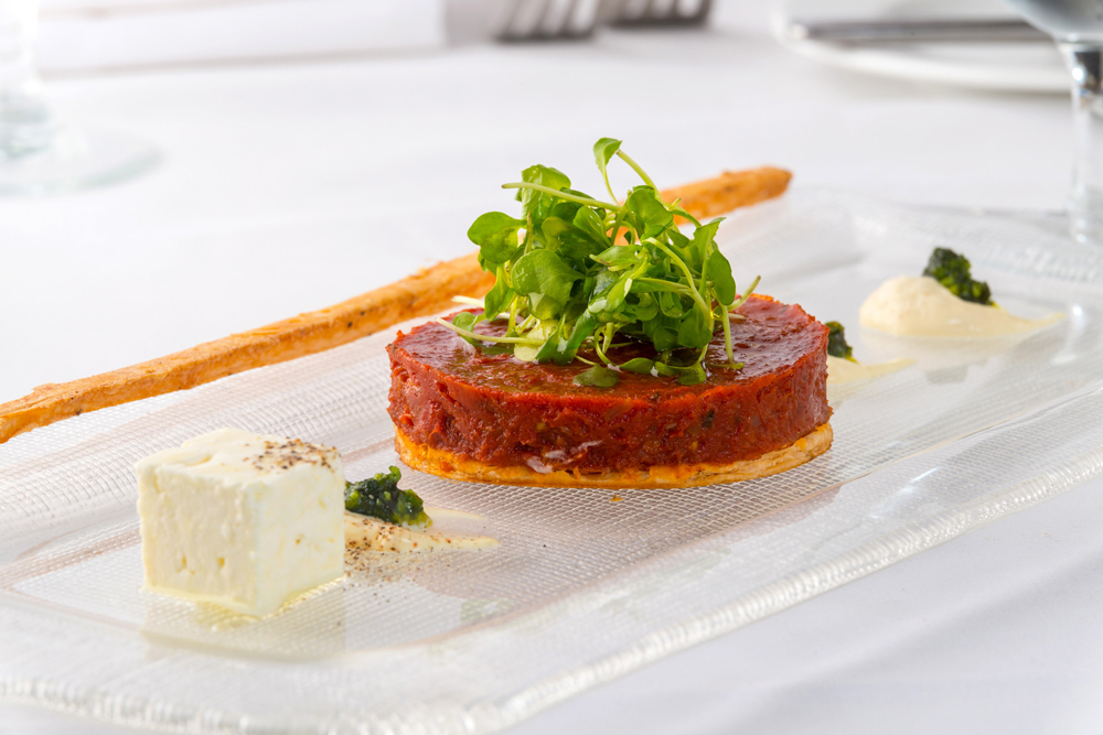 Pascal' on Ponce serves this tomato tatin with sheep milk cheese, mustard , creme fraiche, and garden salad.