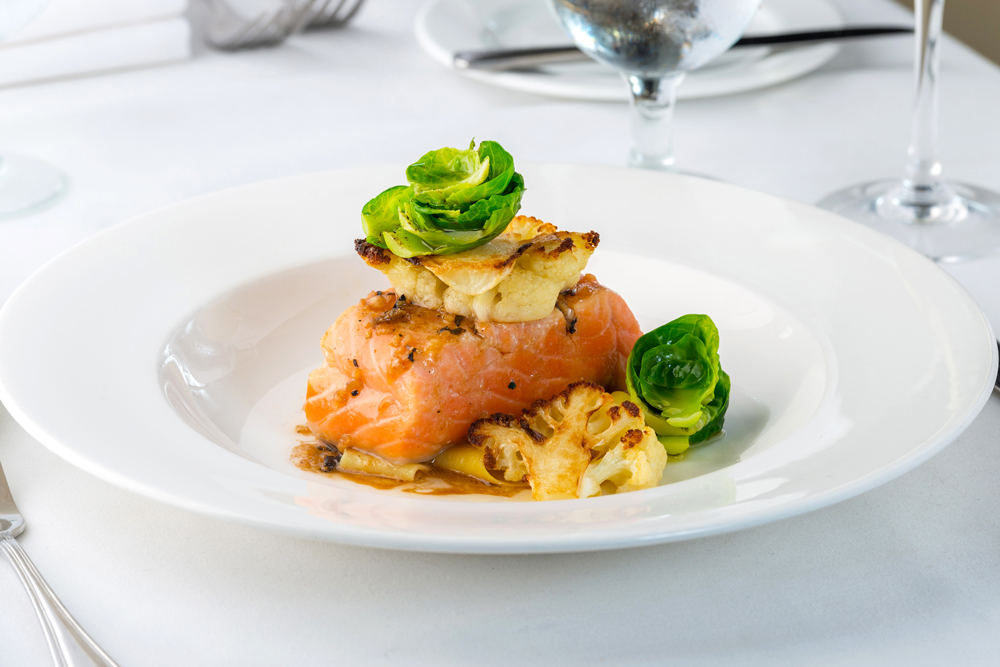 Wild Salmon slowly poached in olive oil served over papardelle pasta with a side of caramelize cauliflower.