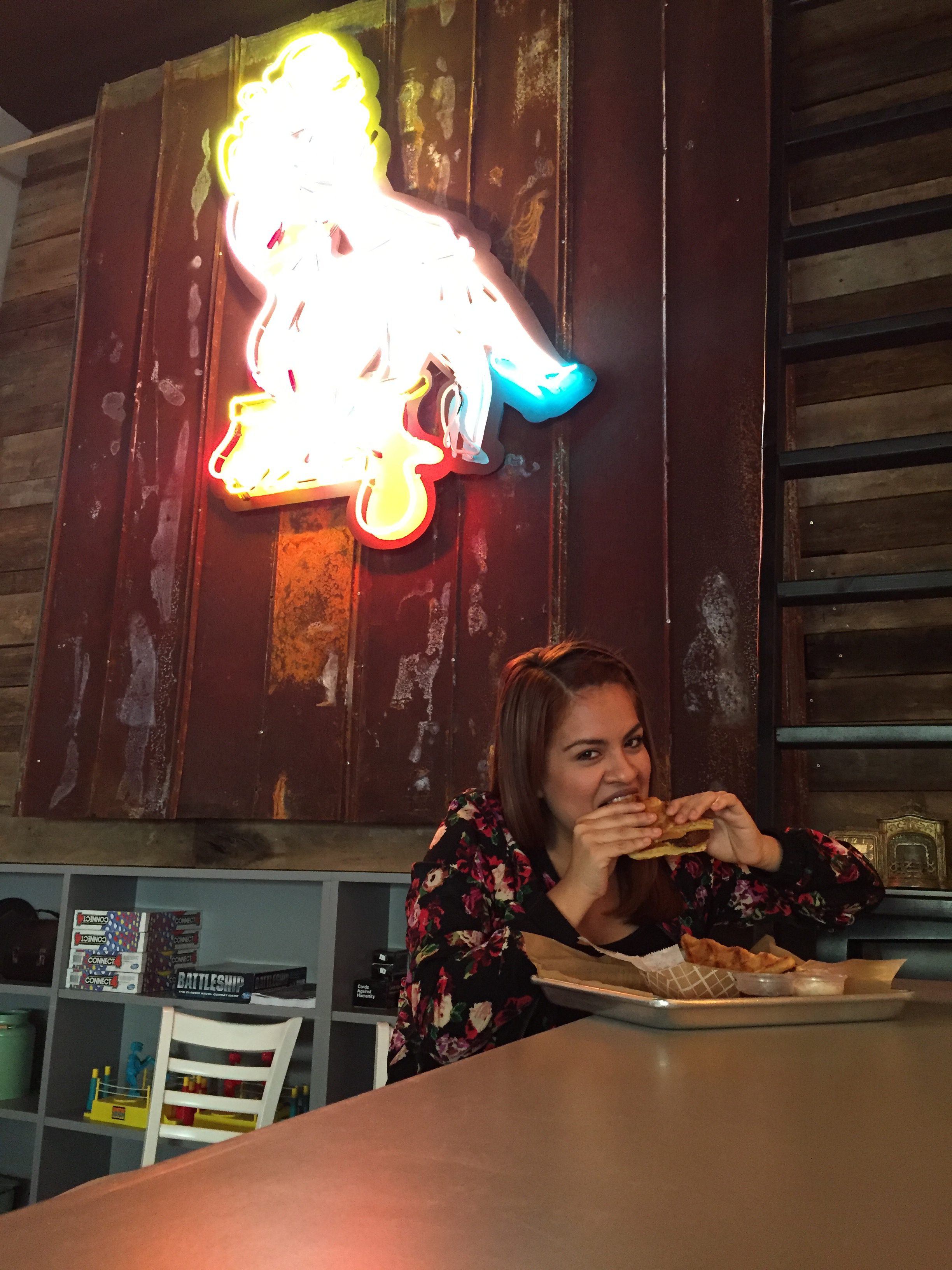 Rosa eating the popular Southern Fried Chicken and Waffle from Ms. Cheezious