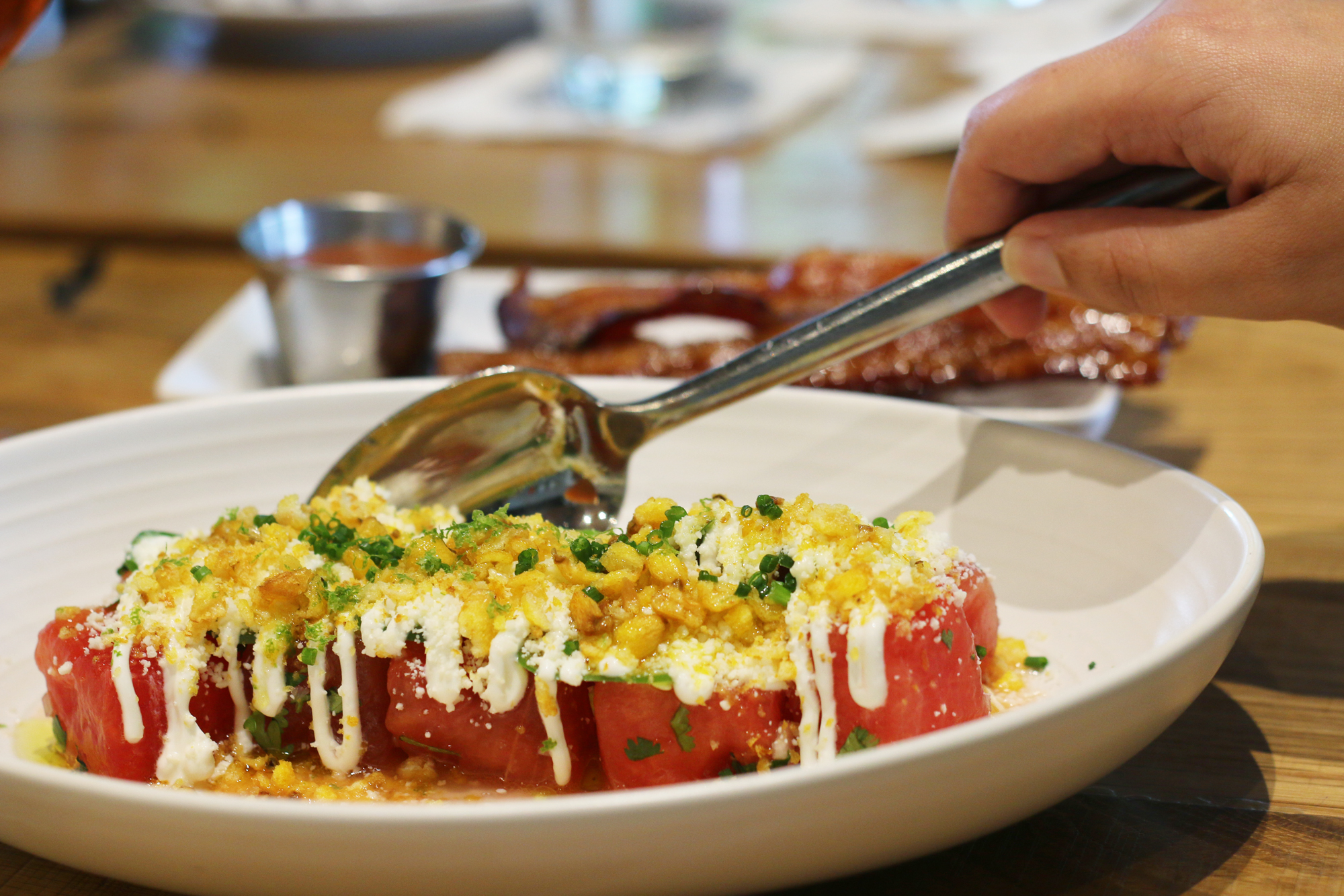 Watermelon salad with Mexican cheese, roasted coran and jalapenos from restaurant Glass & Vine in the Grove. It's AMAZING! Click to read more or pin and save for later! Coral Gables | Miami | Coconut Grove | Florida