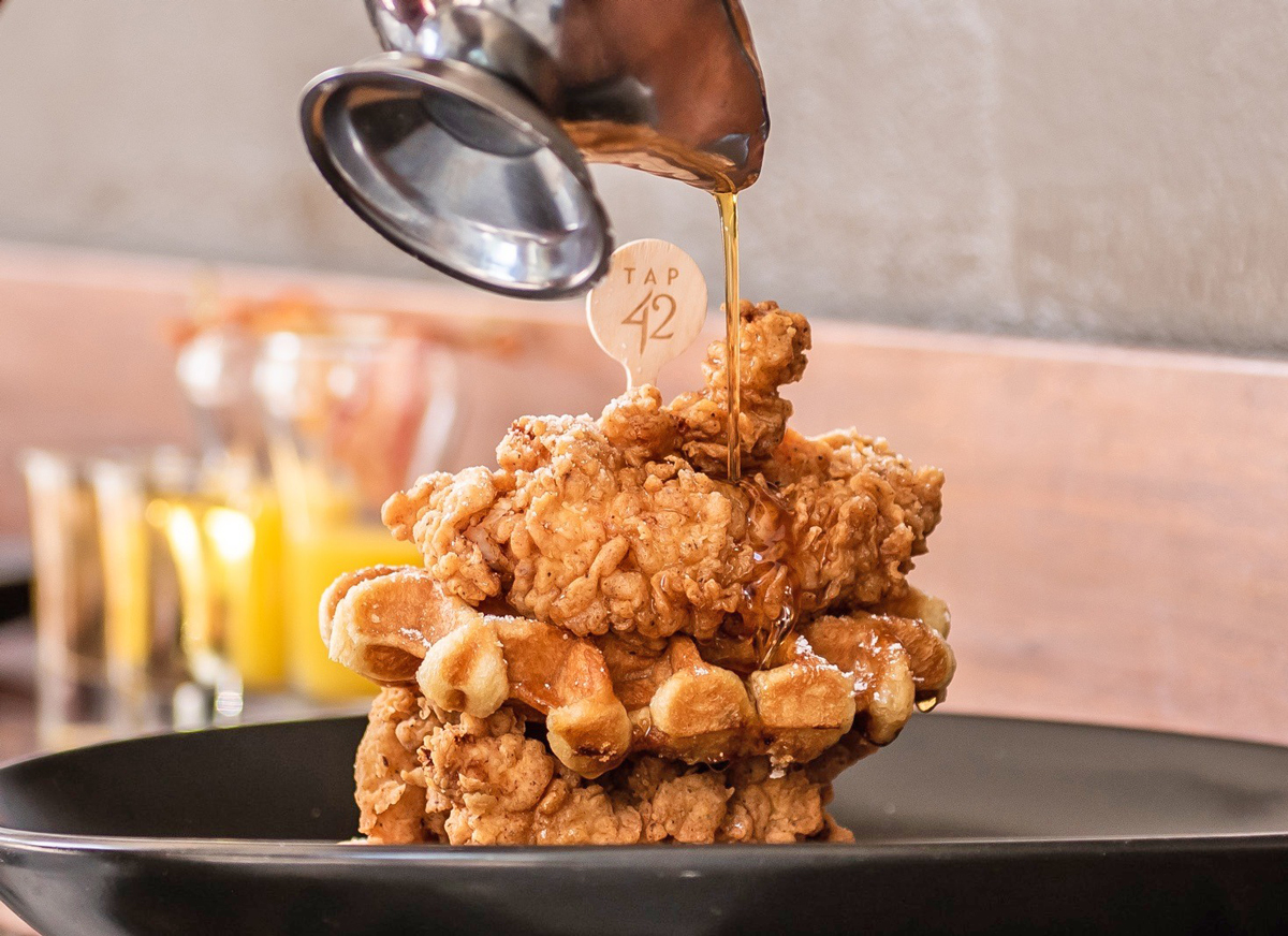chicken and waffles from Best Miami Party Brunch Tap 42 in Coral Gables with Bottomless mimosas and a live DJ
